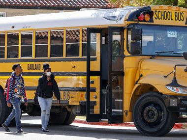 Students board a Garland ISD bus outside Garland High School.