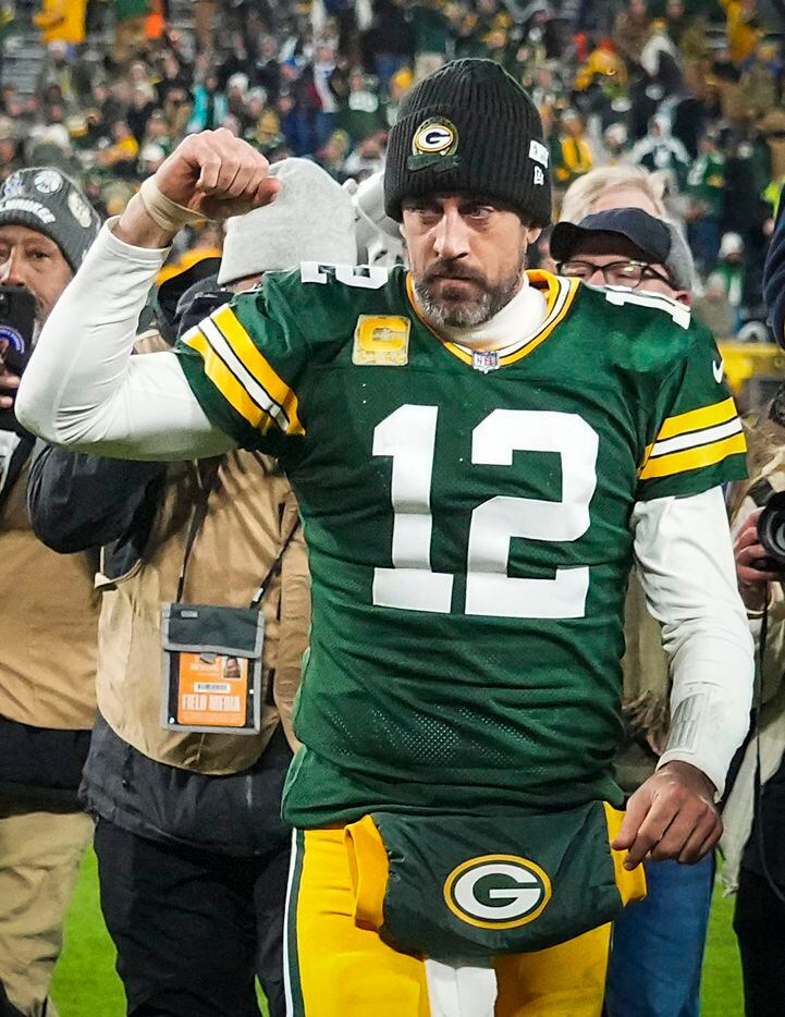 Green Bay Packers quarterback Aaron Rodgers celebrates as he leaves the field after an...