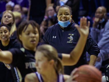 Pinkston girls basketball head coach Nicole Stovall, center, coaches her team during the...