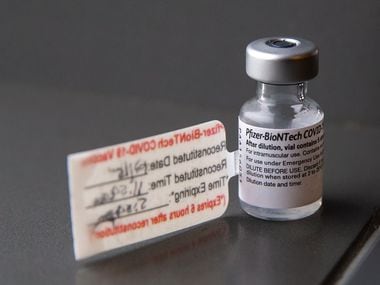 A vial containing five doses of the Pfizer COVID-19 vaccination during a media event at Parkland Hospital in Dallas on Tuesday, Dec. 15, 2020. (Lynda M. González/The Dallas Morning News)