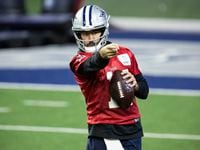Dallas Cowboys quarterback Ben Dinucci signals to a teammate during practice at The Star in...