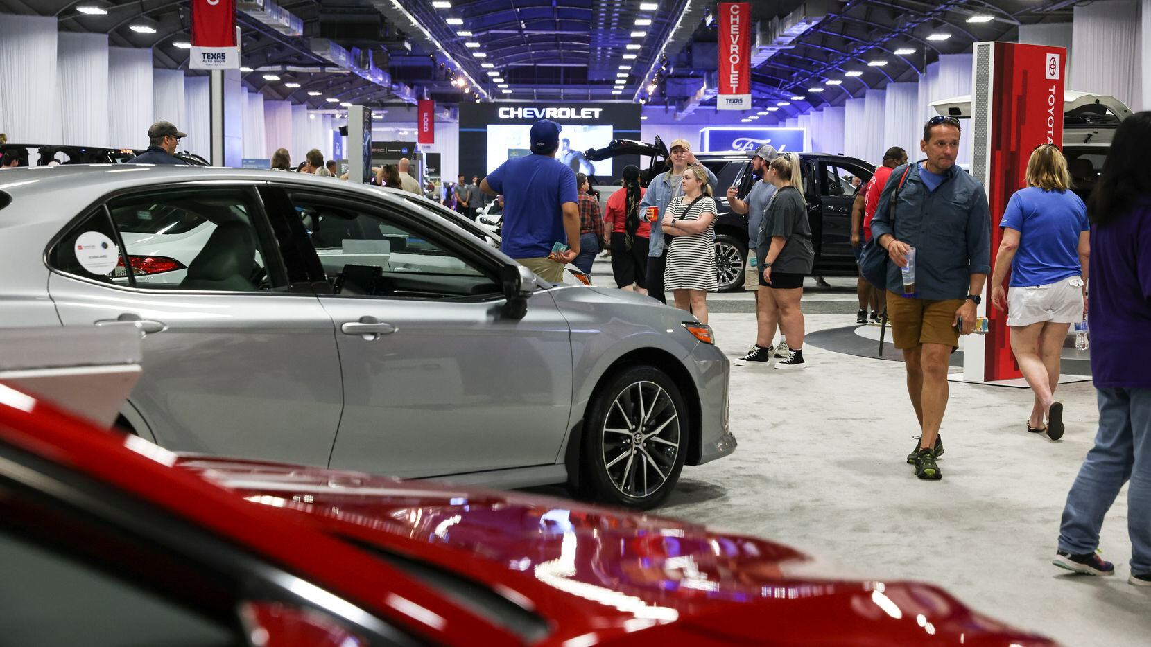 People walk around the auto show during the State Fair of Texas, Sunday, Oct. 2, 2022 at...