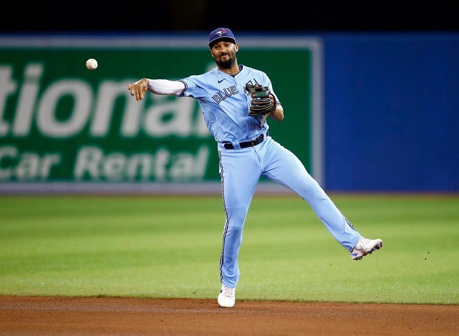 Marcus Semien, then of the Toronto Blue Jays, throws to first base during a MLB game against...