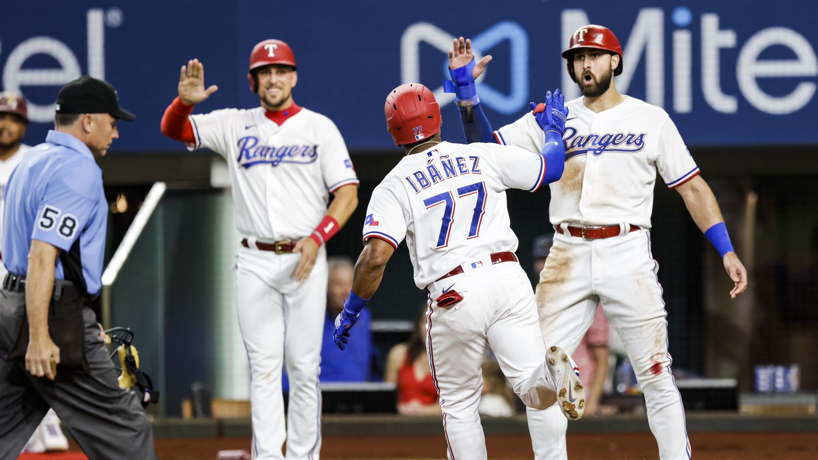 Texas Rangers’ Andy Ibanez (77) is congratulated after hitting a three-run home run during...