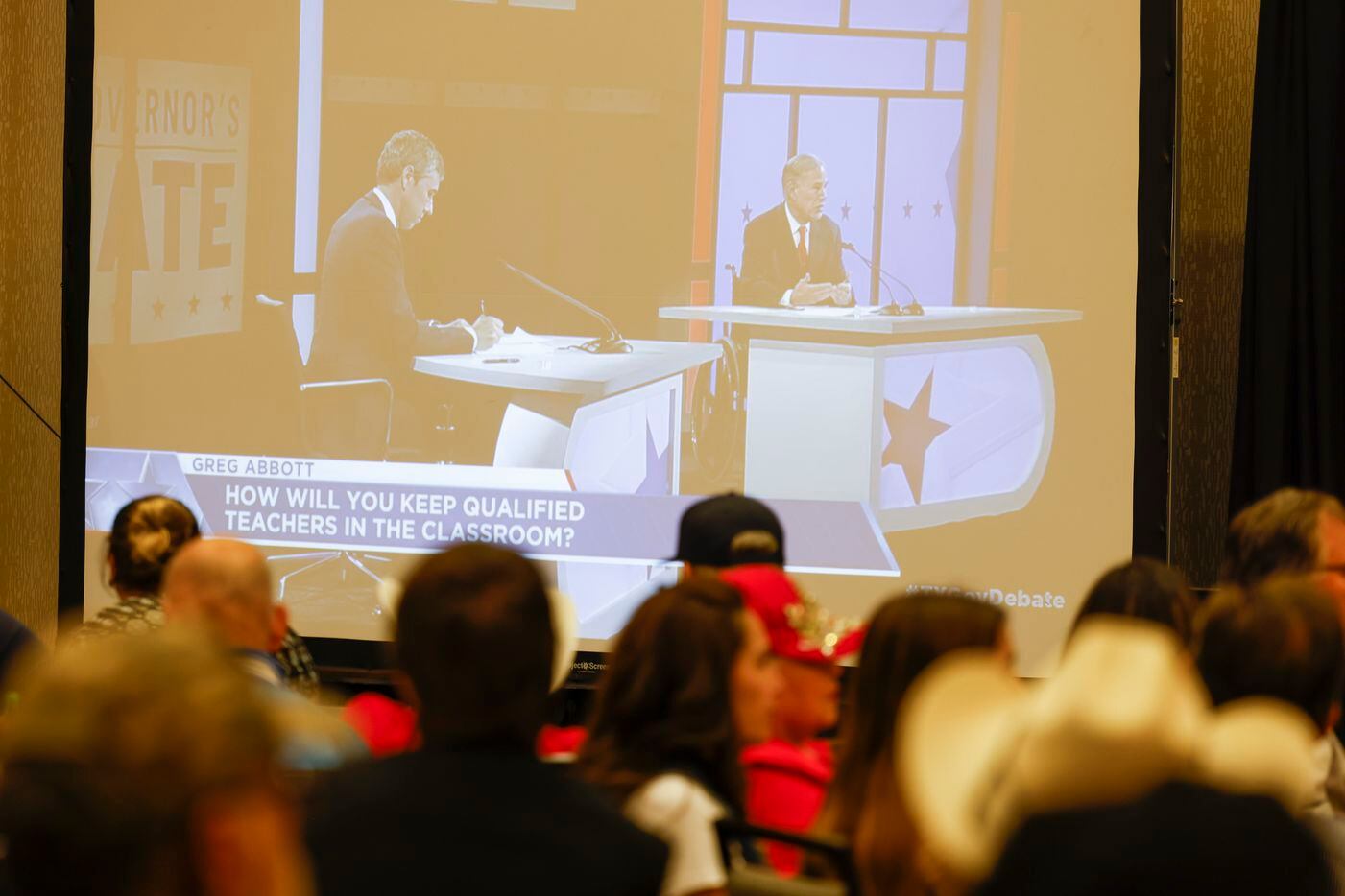 Supporters of Texas Govorner Greg Abbott watch the debate against Democratic gubernatorial...