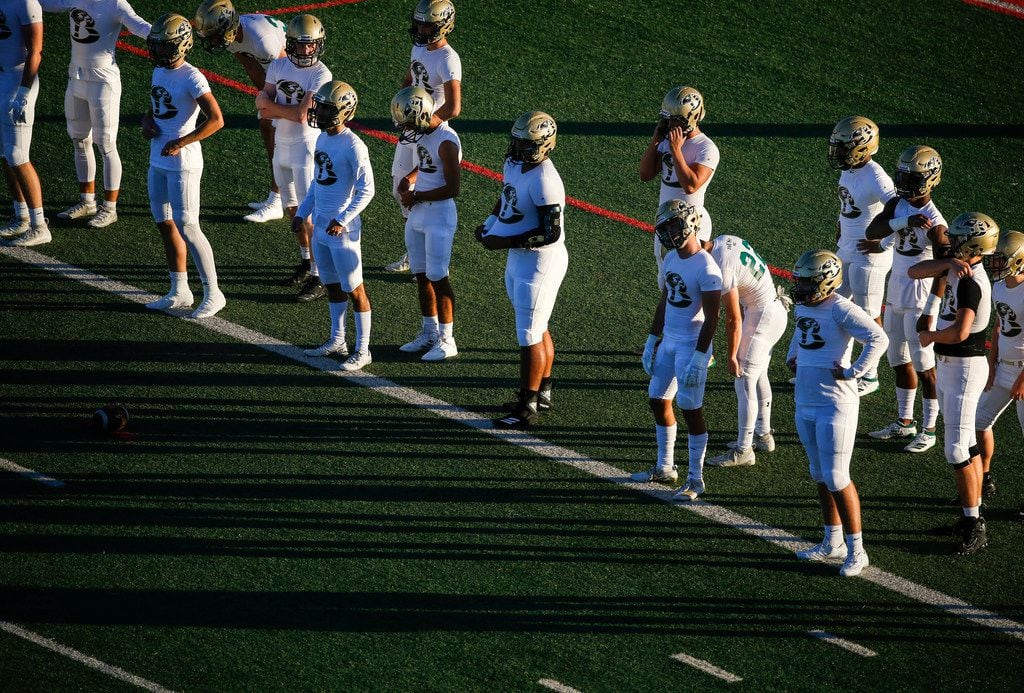 Birdville players warm up prior to a high school football game between Colleyville Heritage...