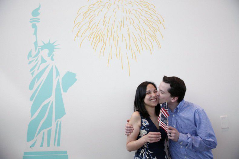  Phillip Stromberg kisses his wife, Julieta Chiquillo, after she became a U.S. citizen on...