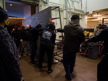 The AT&T Performing Arts Center crew unloads set pieces made by Dallas Stage Scenery for...