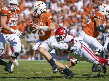 FILE - Texas quarterback Sam Ehlinger (11) is sacked by Oklahoma defensive lineman Neville Gallimore (90) during the first half of an NCAA football game at the Cotton Bowl on Saturday, Oct. 12, 2019, in Dallas.