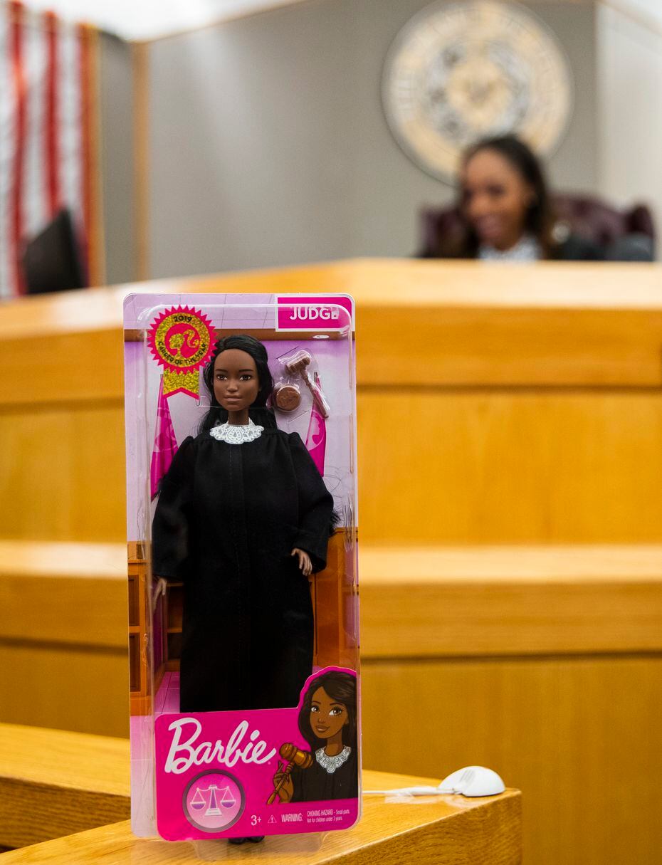 A Judge Barbie doll stands near Dallas County Criminal Court Judge Shequitta Kelly in her...