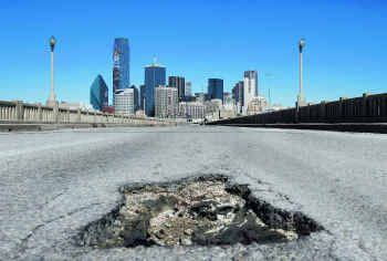 Dallas City Hall has long had more needs than funds to meet them. This image shows a pothole...