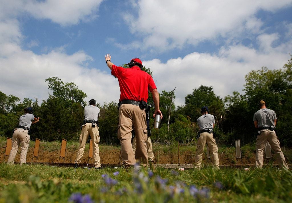Firearms instructor Allen Lash leads Dallas Police Academy students during training at the...