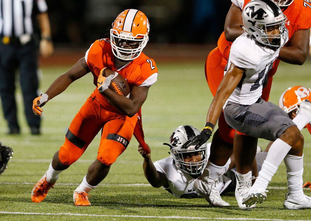 Arlington Martin's Kenneth Taylor (24) holds on tight to the jersey of Rockwall's Khalil...