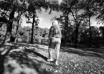 Lee Sneller, who is in the early stages of Alzheimer's disease, takes a daily walk in his...