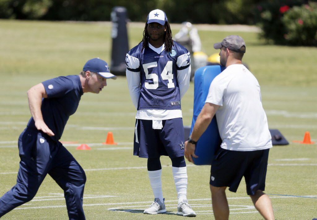 Dallas Cowboys linebacker Jaylon Smith (54) watches coaching staff demonstrate drills during...