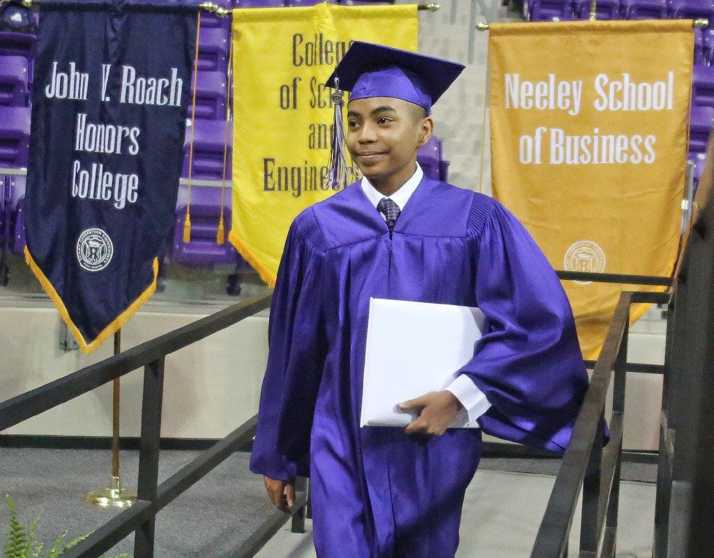 14-year-old Carson Huey-You walks off the stage after receiving a bachelor's degree in...