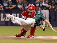 Prosper’s Harrison Rosar is tagged out by Coppell catcher Walker Polk (23) at home plate...