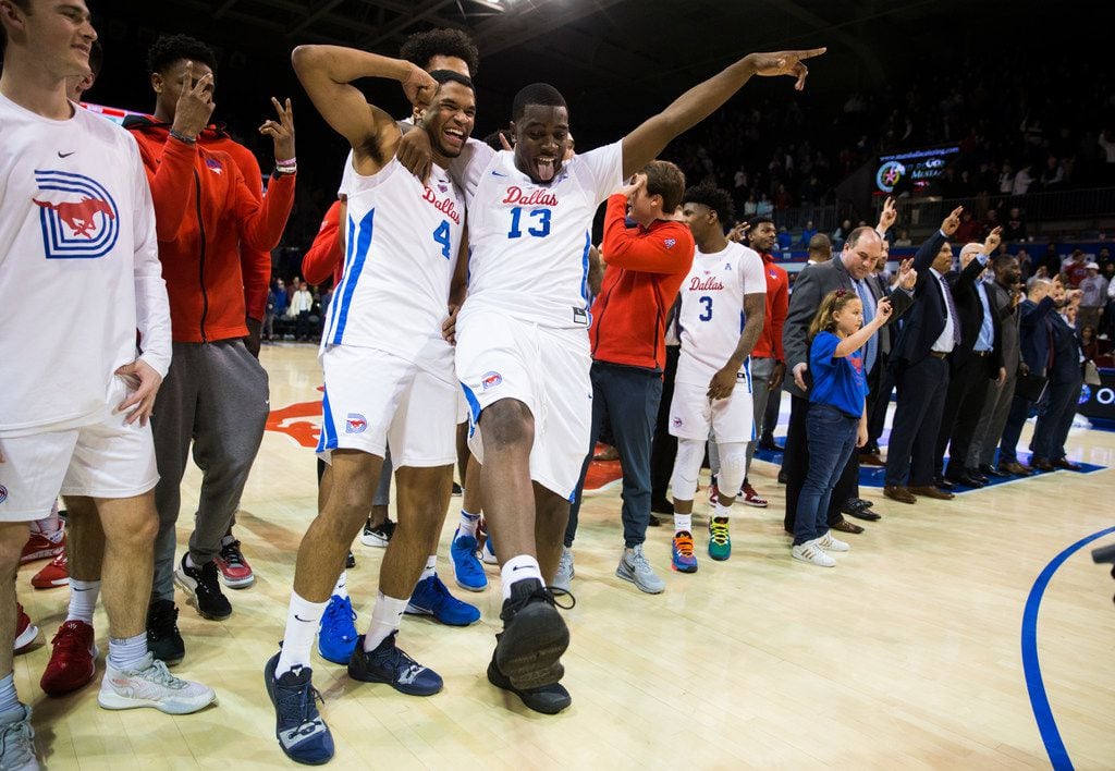 Southern Methodist Mustangs guard Charles Smith IV (4) and guard CJ White (13) celebrate a 73-72 overtime win after a basketball game between SMU and University of Houston on Saturday, February 15, 2020 at Moody Coliseum in Dallas.