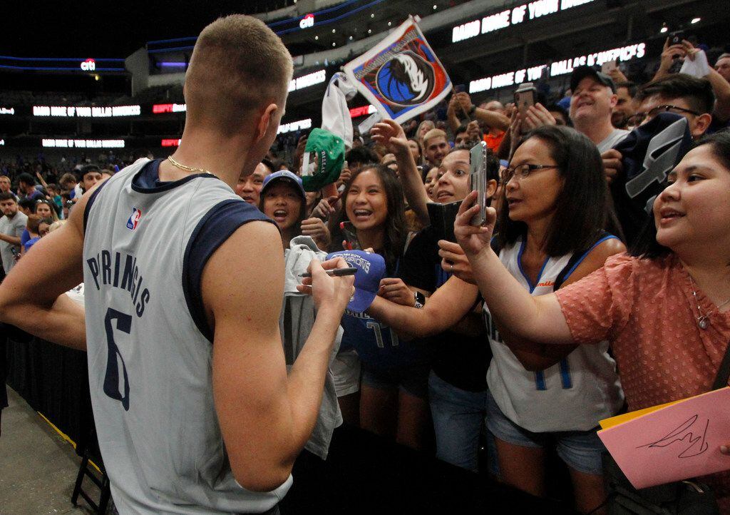 Dallas Mavericks center signs autographs and poses for group selfies for excited Mavericks...