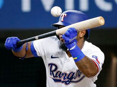 Texas Rangers batter Yonny Hernandez (65) bunts out to third base during his third inning...