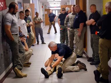 Advanced Law Enforcement Rapid Response Training instructor Troy Dupuy (left) shows how to...