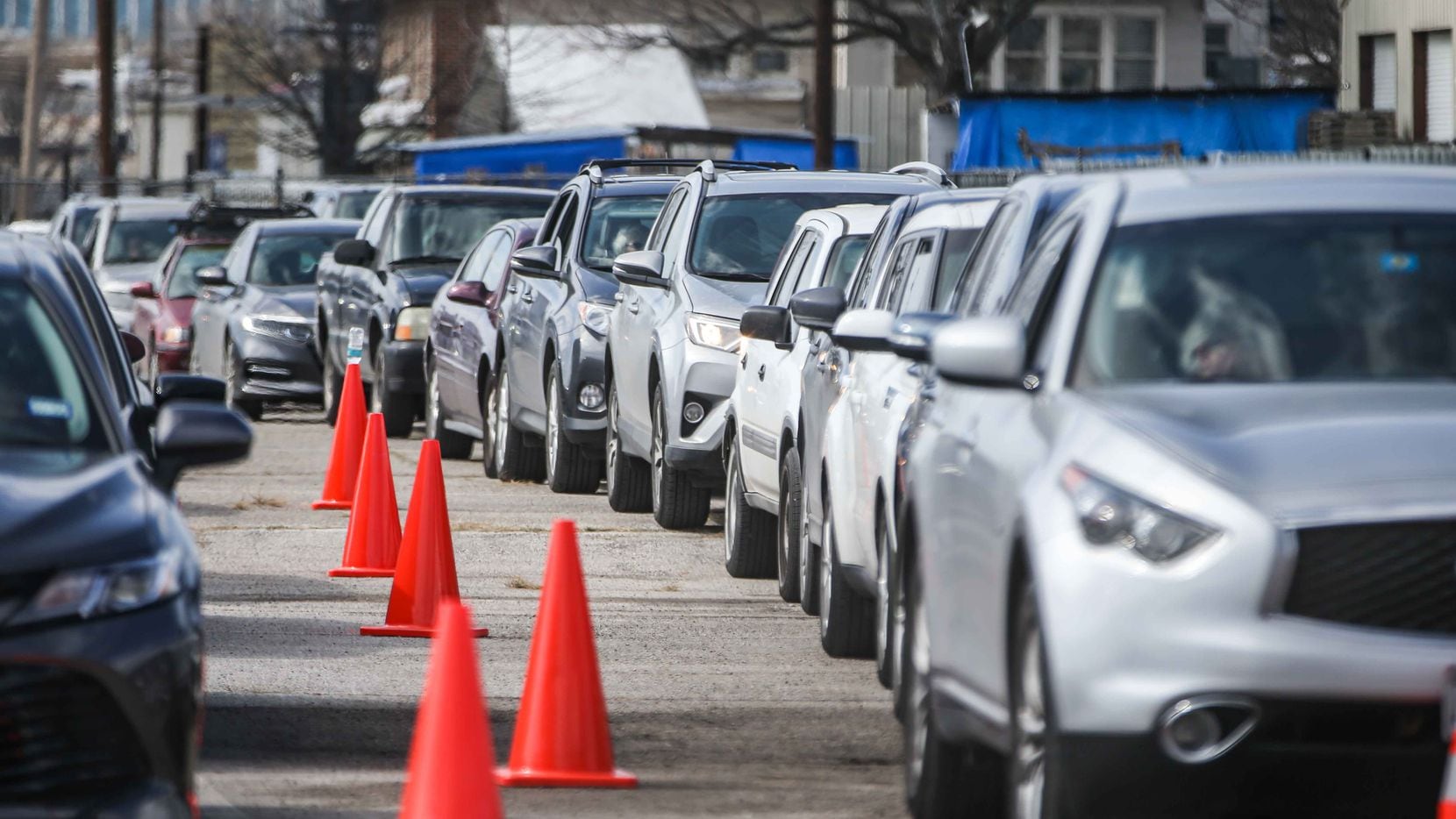 People in a long line of cars get ready for their second doses at Fair Park in Dallas County on Sunday, February 21, 2021.