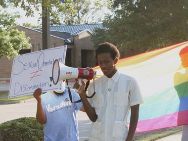 Devin Bryant stands in protest outside of Covenant Christian Academy in Colleyville on Aug. 20, 2020. Bryant, 18, says he was expelled for being gay.