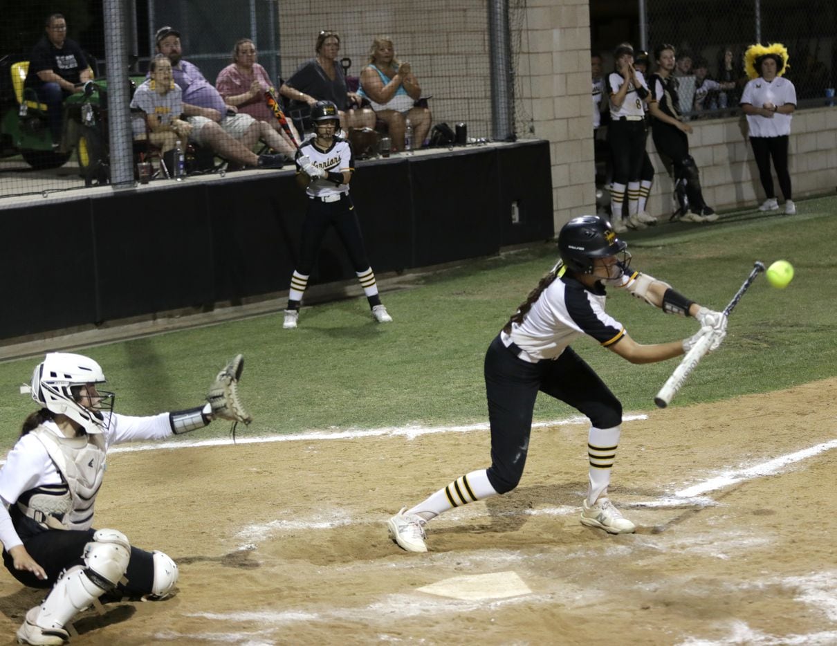 Frisco Memorial High School #13, Madelyn Muller, goes for a bunt during a softball game...
