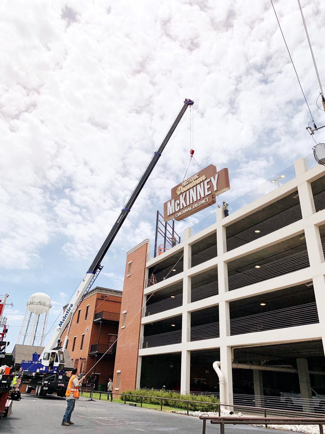 A 30-foot neon sign goes into place on top of the Chestnut Commons Parking Garage at the...