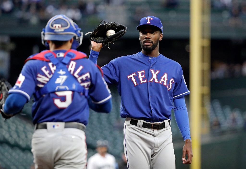 Texas Rangers starting pitcher Taylor Hearn, right, talks with catcher Isiah Kiner-Falefa...