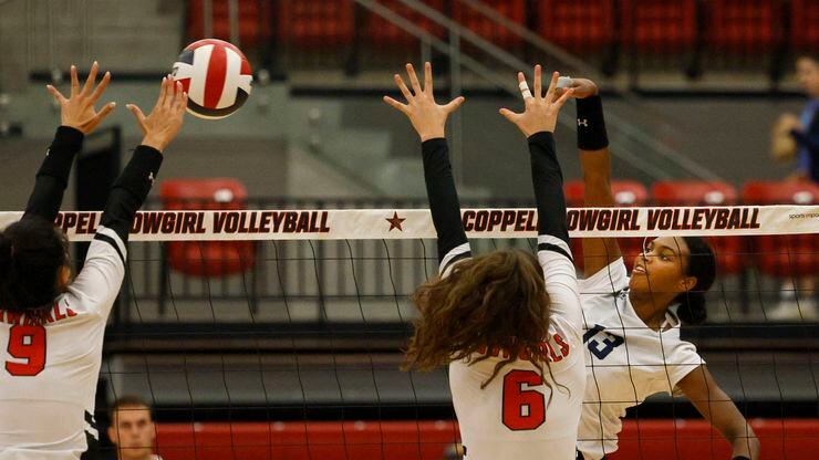 Flower Mound's Brianna Watson (13) spikes the ball as Coppell's Alena Truong (9) and...