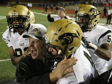 Plano East coach Joey McCullough (bottom left) celebrates with his players after a win over Hebron in 2015. (Andy Jacobsohn/The Dallas Morning News)