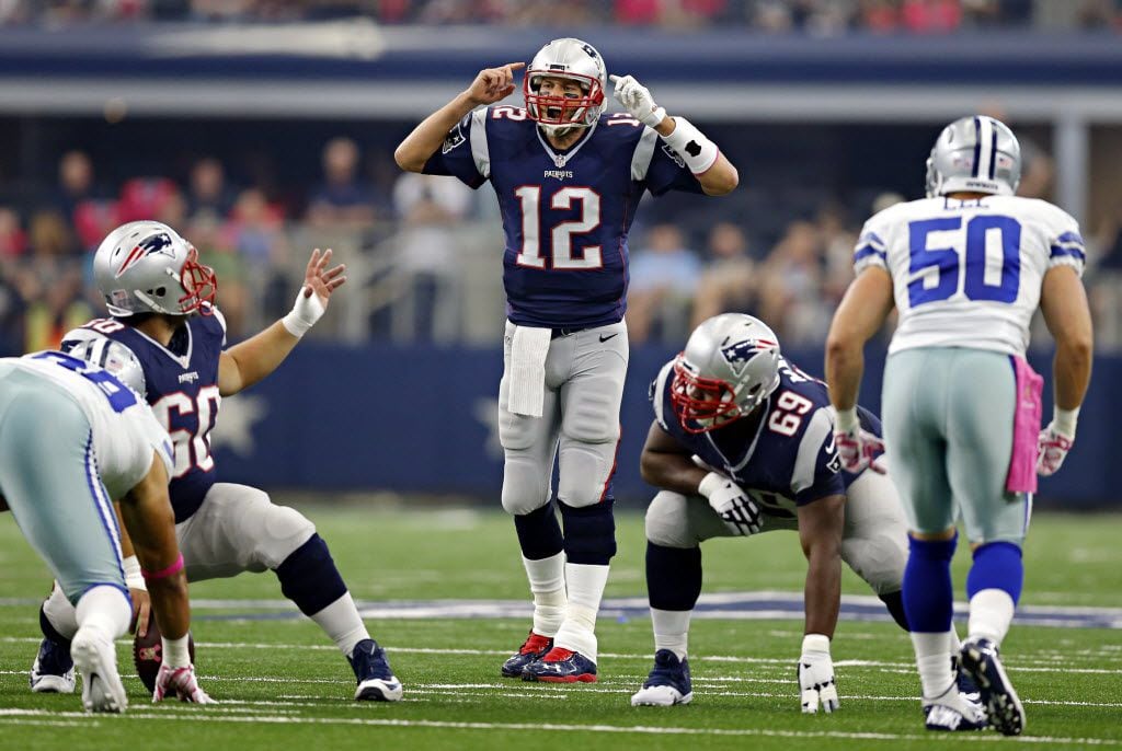 New England Patriots quarterback Tom Brady (12) calls a play at the line during the first...