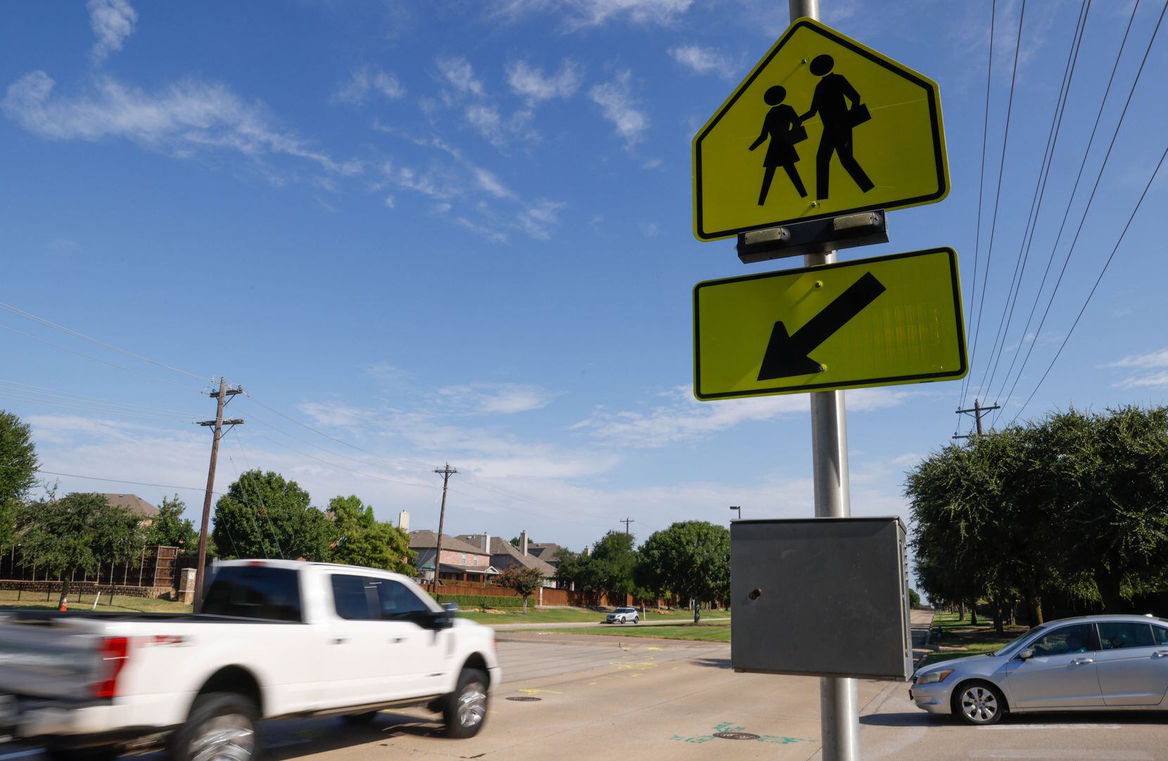 Signs mark the pedestrian walkway where a teen riding a bicycle was struck and killed by a...