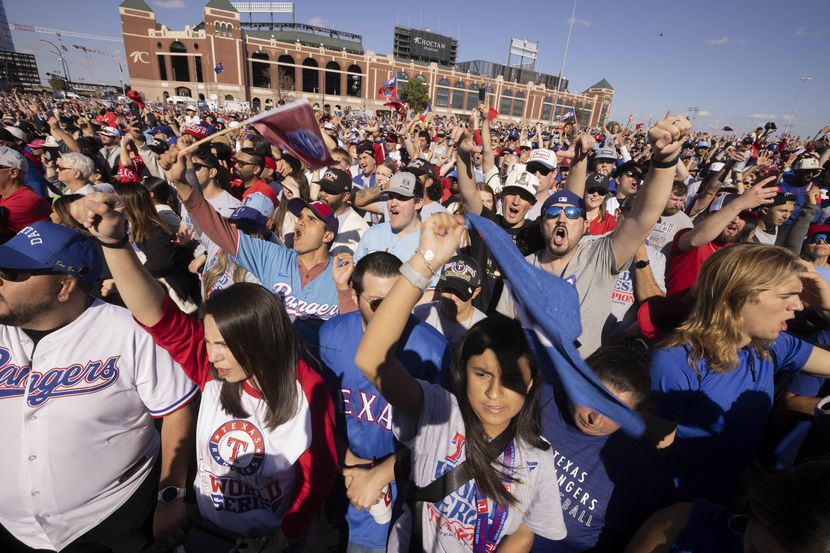 Texas Rangers fans cheer at Globe Life Field’s Lot B in Arlington as the team takes the...