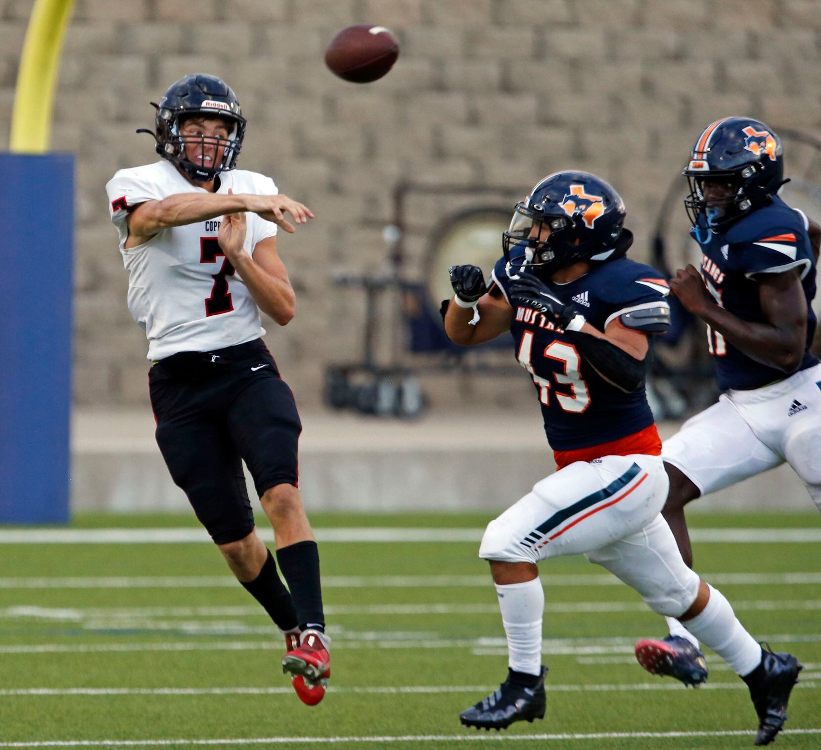 Coppell QB Jack Fishpaw (7) throws a pass under pressure by Sachse defender Jonathan Chian...