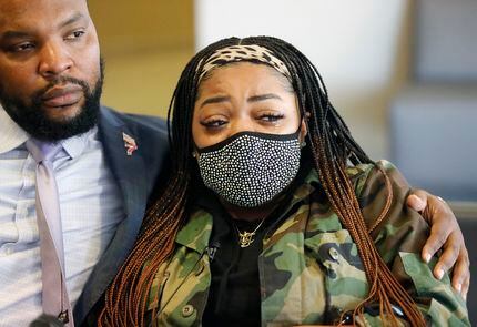 Civil-rights attorney Lee Merritt comforted LaChay Batts, sister of Marvin Scott III, during...