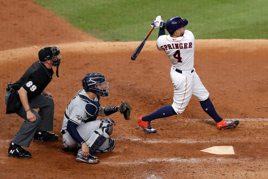 Astros outfielder George Springer hits a solo home run in the fifth inning in Game 2 of the ALCS against the Yankees on Oct. 13, 2019, at Minute Maid Park in Houston.