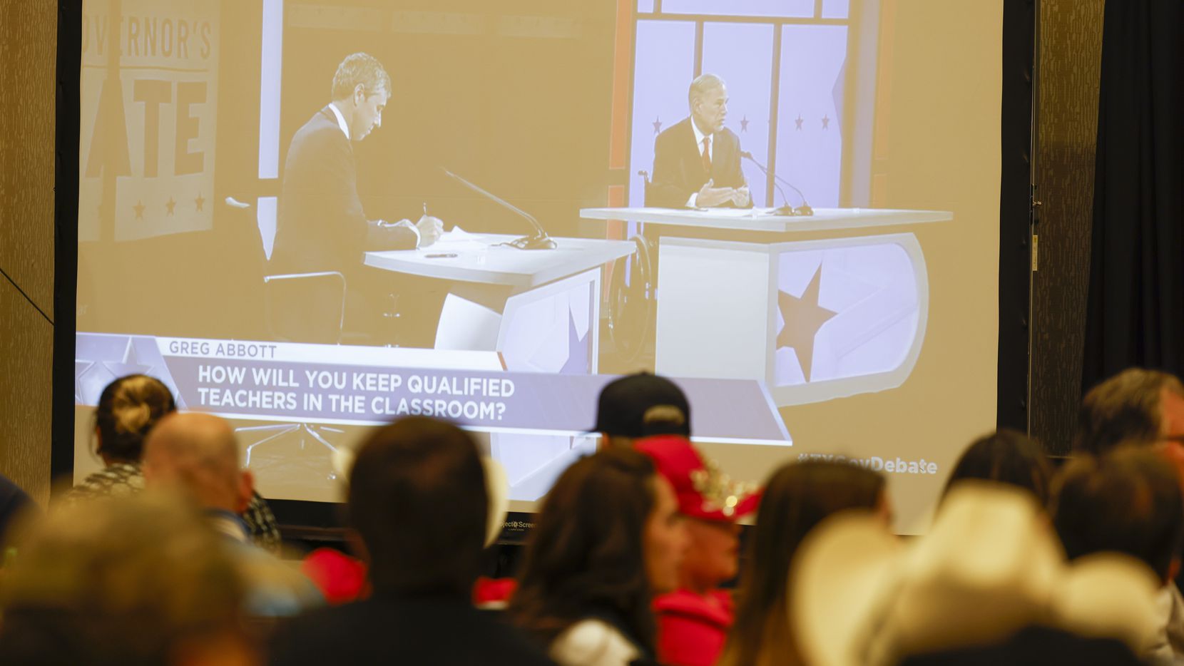 Supporters of Texas Govorner Greg Abbott watch the debate against Democratic gubernatorial...