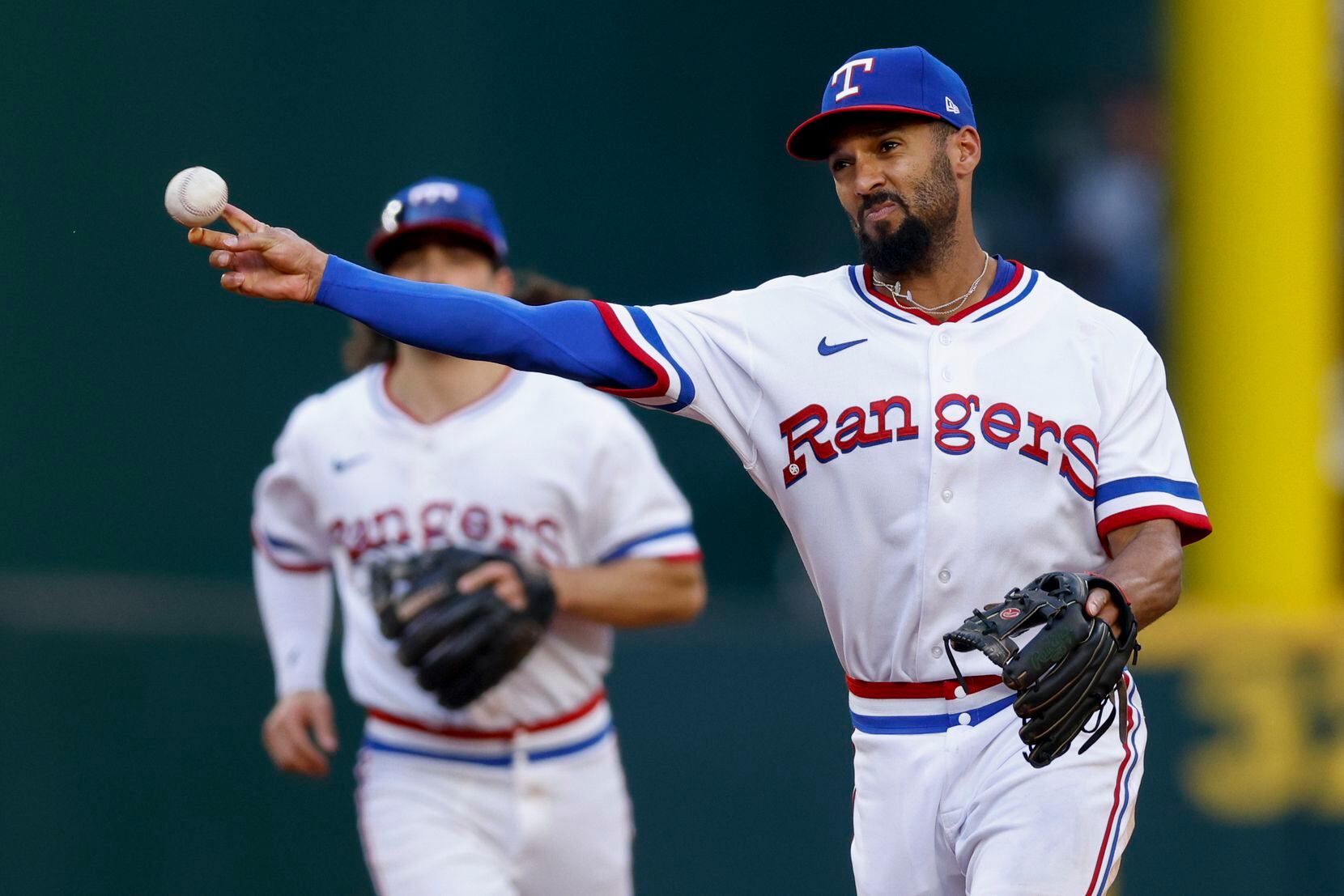 Texas Rangers second baseman Marcus Semien (2) throws to first base for an out during the...