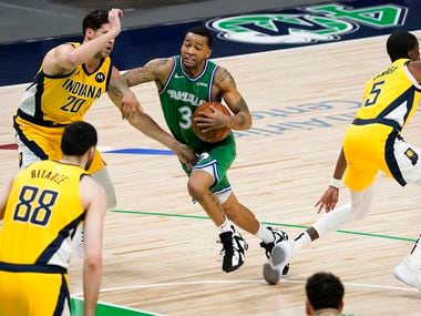 Dallas Mavericks guard Trey Burke (3) drives to the basket against Indiana Pacers forward Doug McDermott (20) during the first half of an NBA basketball game at American Airlines Center on Friday, March 26, 2021, in Dallas.