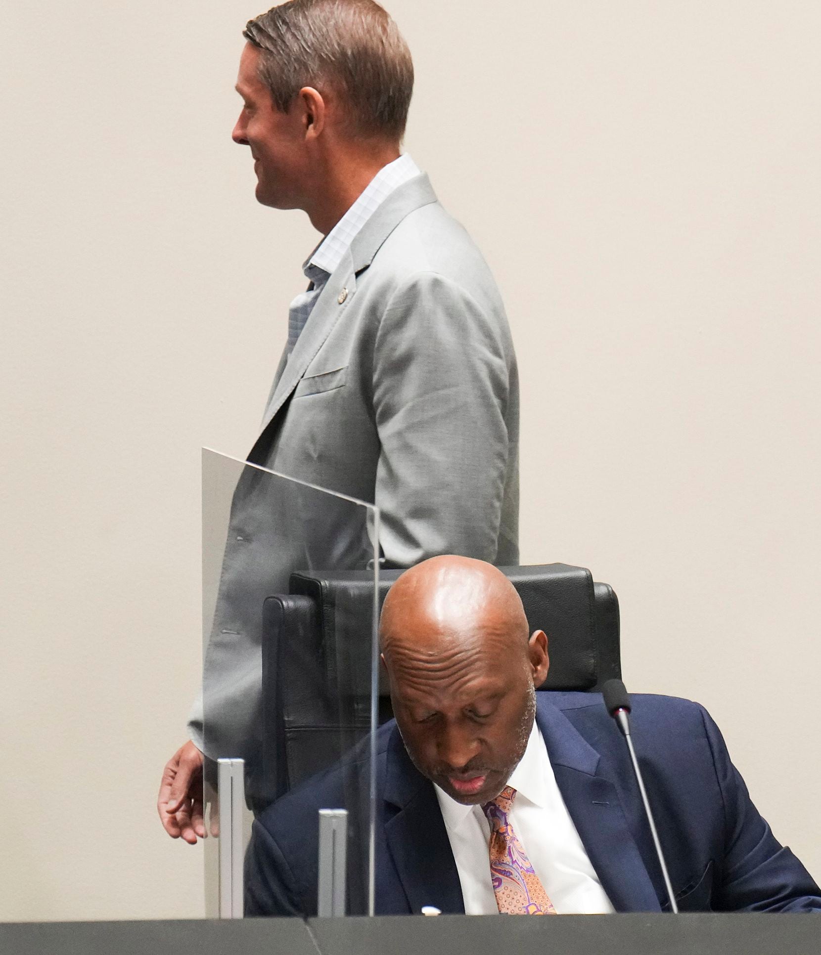 Dallas City Manager T.C. Broadnax listens to public comment as Mayor Pro Tem Chad West walks...