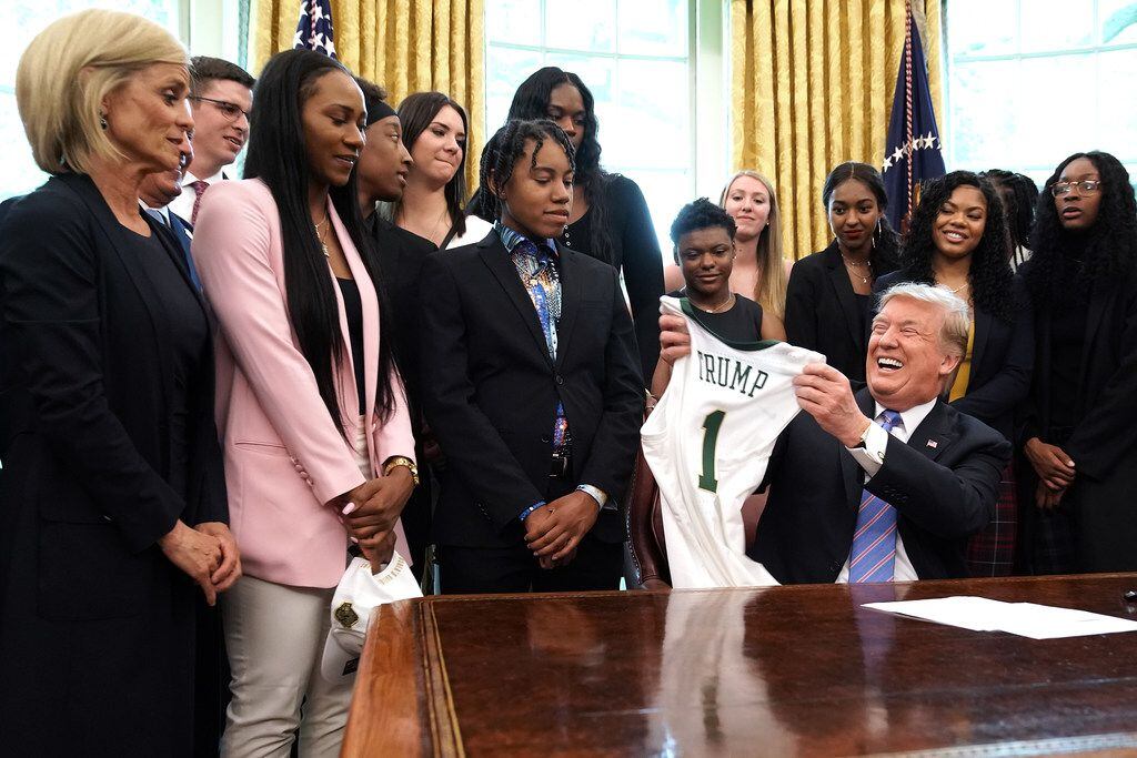Coach Kim Mulkey, left, and the Baylor women's basketball team present President Donald...