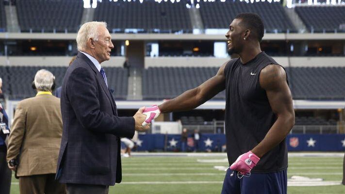 Dallas Cowboys owner Jerry Jones, left, and wide receiver Dez Bryant shake hands on the...