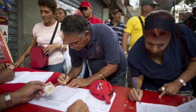 Simpatizantes del presidente Nicolás Maduro firman una petición para que Estados Unidos...