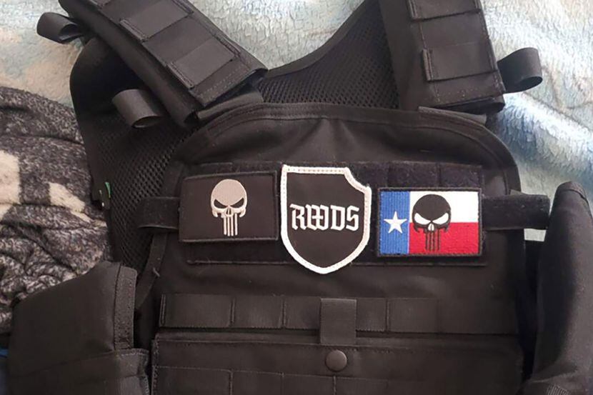 Image of a tactical vest with patches of the "Punisher" skull and "right-wing death squad,"...