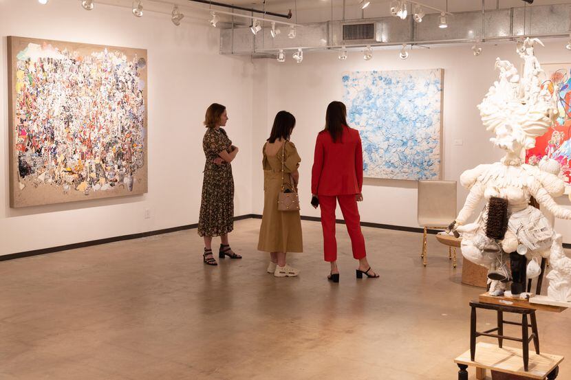 Guests look at a piece of artwork at the Dallas Art Fair.