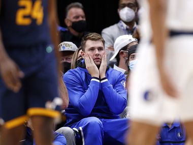 Dallas Mavericks guard Luka Doncic reacts to a second half play as he watches the game against the Utah Jazz from the bench at the American Airlines Center in Dallas, Wednesday, October 6, 2021. The Mavericks defeated the Jazz, 111-101.