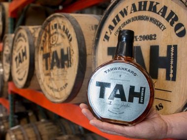 Chris Vivion holds a first-batch bottle of Tahwahkaro four-grain bourbon whiskey at the companyâ€™s distillery in Grapevine, Texas on June 7, 2019. (Robert W. Hart/Special Contributor)