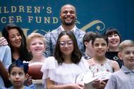 Dallas Cowboys Dak Prescott does for a photo with pediatric patient models for the upcoming...